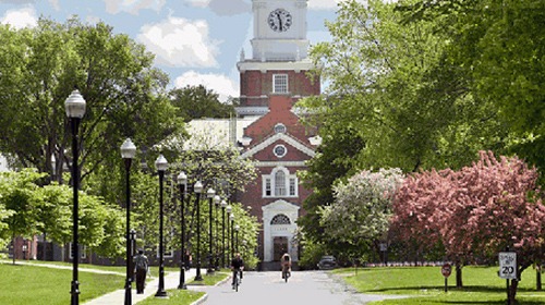 artmouth College campus with a brick building and clock tower, representing the historic & academic