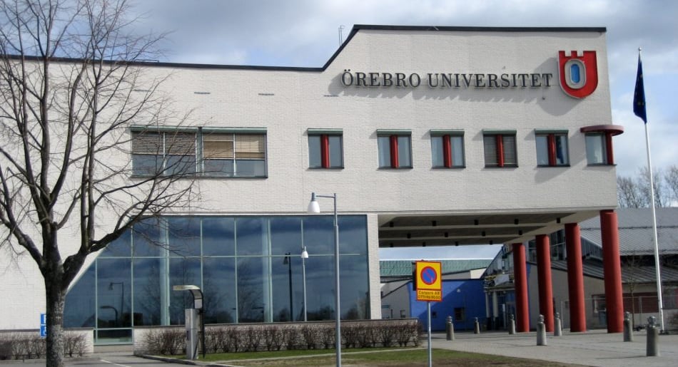 Exterior view of Örebro University building with glass facade and prominent logo
