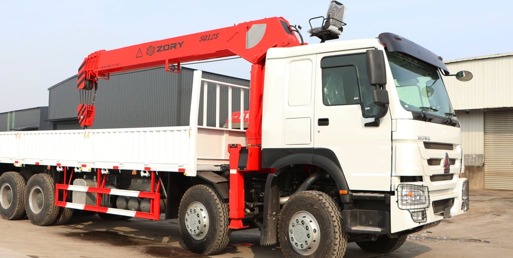 A telescopic boom truck mounted crane, a large truck with a crane on it, lifting heavy objects efficiently.
