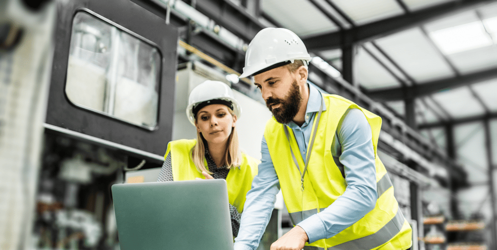 a man and woman in safety vests and hard hats