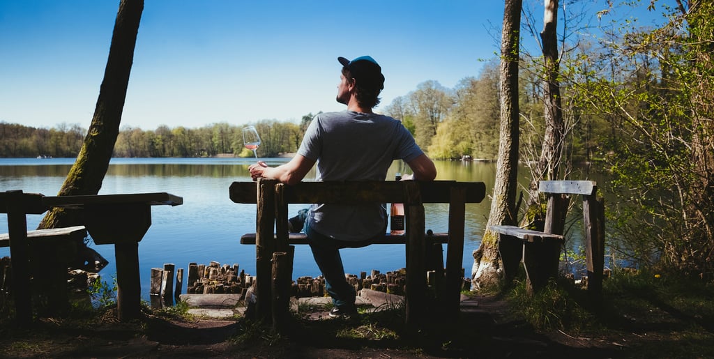 Owner of Siering wine admiring a lake holding a glass of wine.