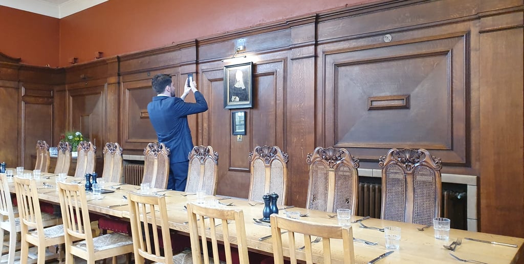 James Syrett photographs the portrait of Lady Margaret Beaufort at Lady Margaret Hall, Oxford