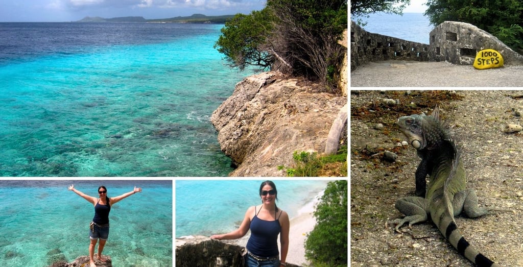 Autora na praia de 1000 Steps, em Bonaire, com escadaria de pedra e água cristalina