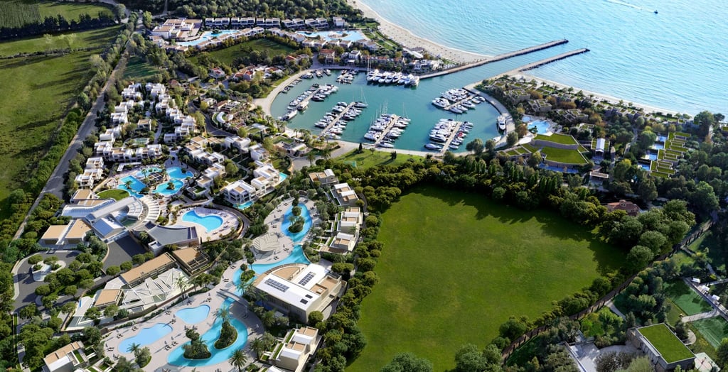 Aerial view of Porto Sani featuring a private marina, turquoise swimming pools, and white villas.