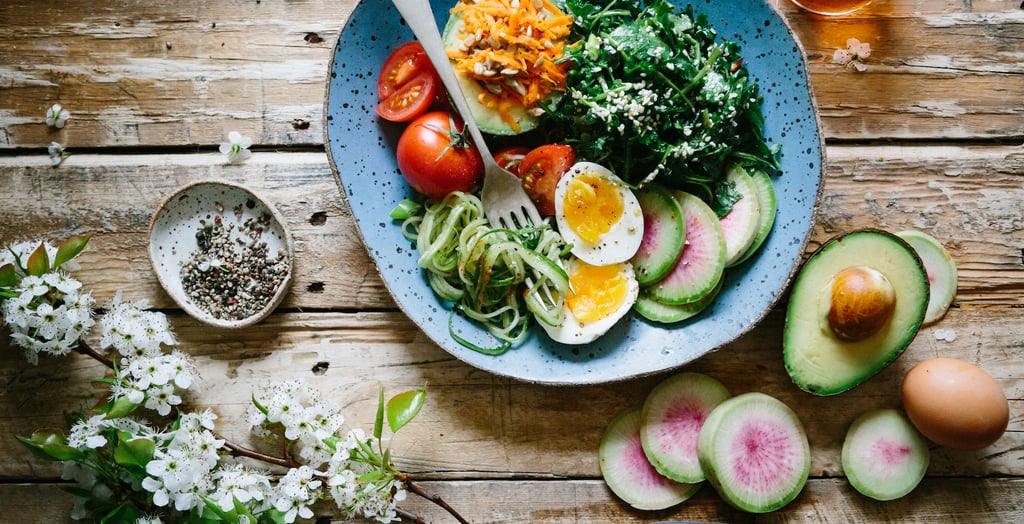 a bowl of food with a fork and knife on a table