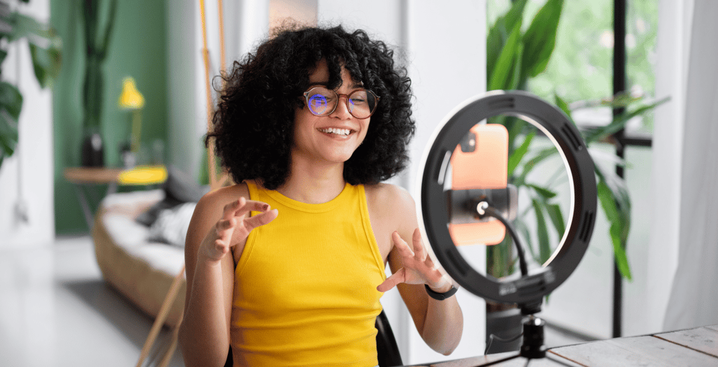 an influencer smiling in front of ring light