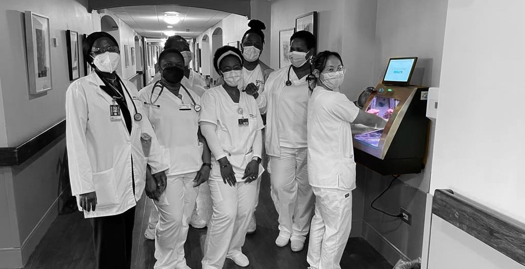 a group of nurses in white scrubies and masks