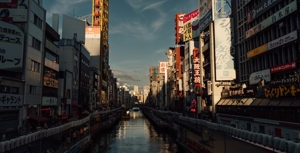 a city street scene with a river running through a city