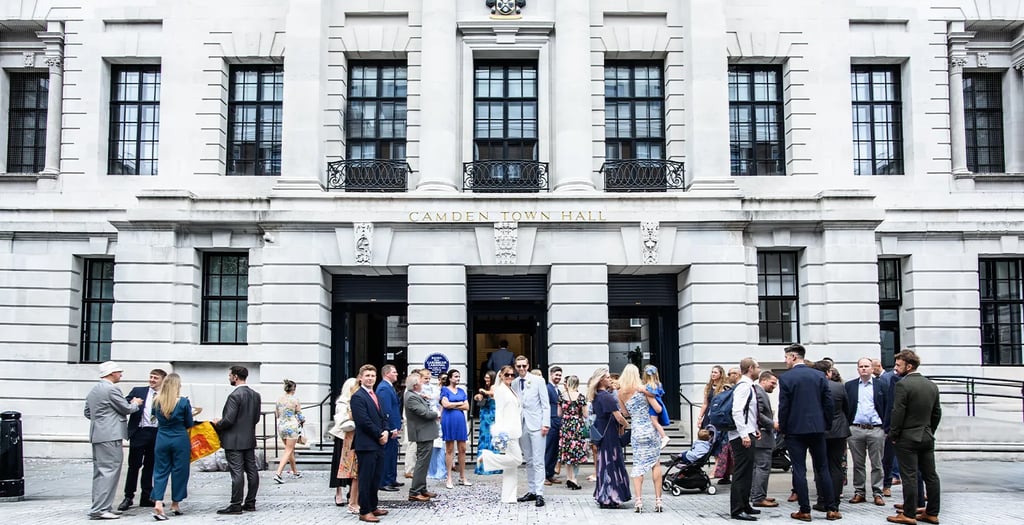 Wedding party standing outside Camden Town hall