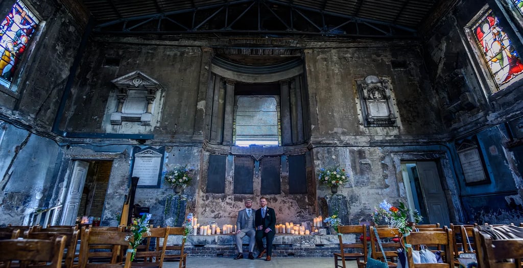 two grooms sitting inside the asylum chapel