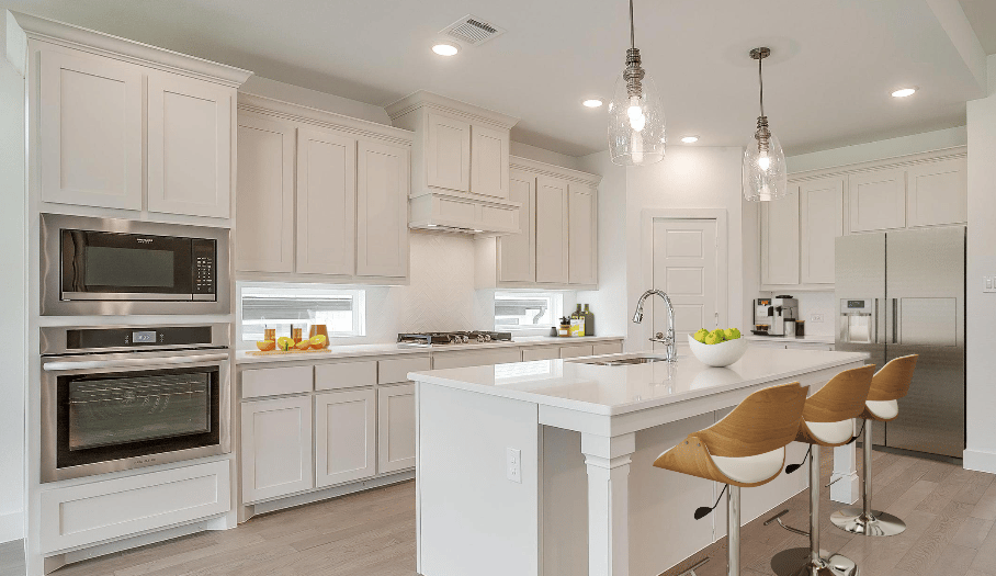 a kitchen with a large island and a bar stool