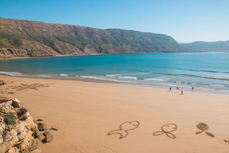 Morocco a couple of people walking on a beach