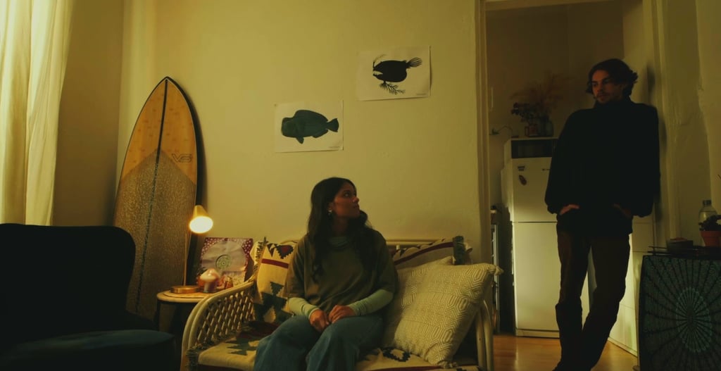 a man and woman sitting on a couch in a living room
