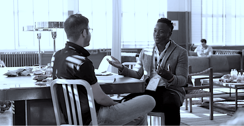 Two business professionals having a collaborative meeting in a modern open office workspace.