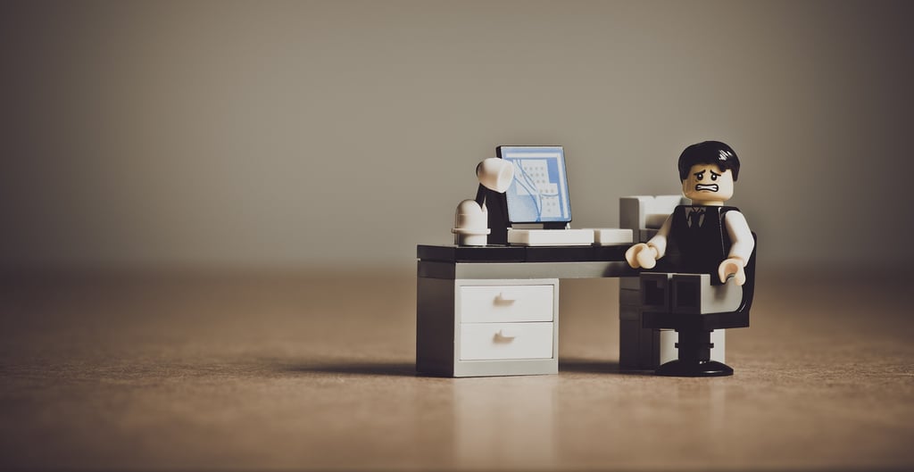 Lego minifigure at a desk symbolizing the challenges and frustrations of international students