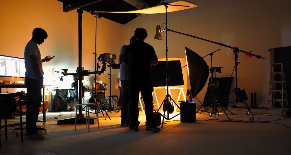 a man standing in front of a camera and a camera