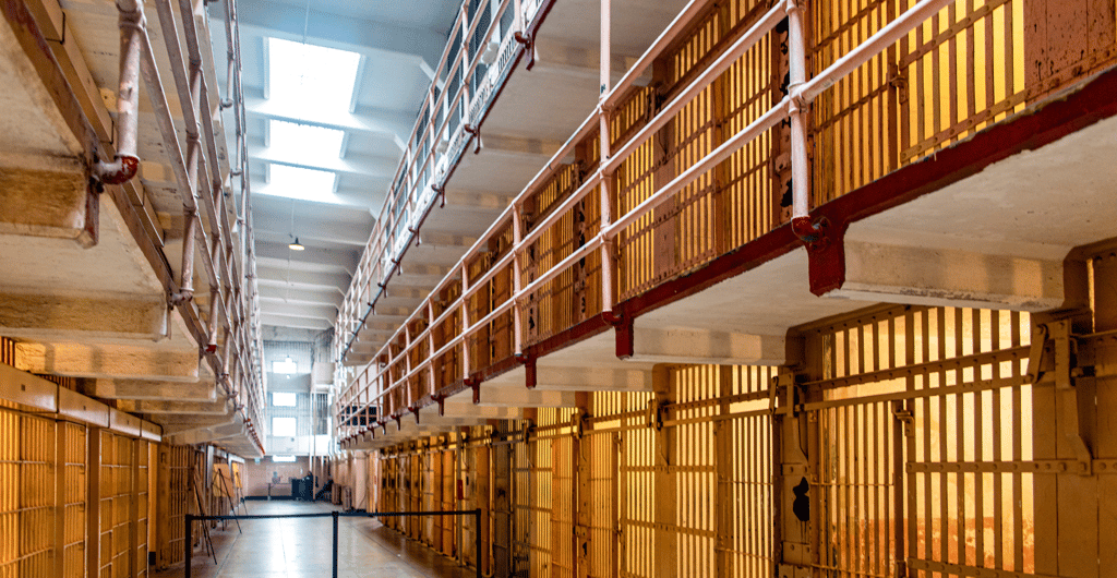 a long prison hallway with a long row of prison bars with bars and bars