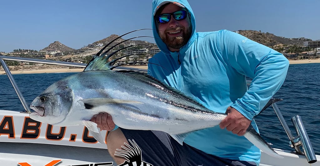 a man holding a fish fish on a boat