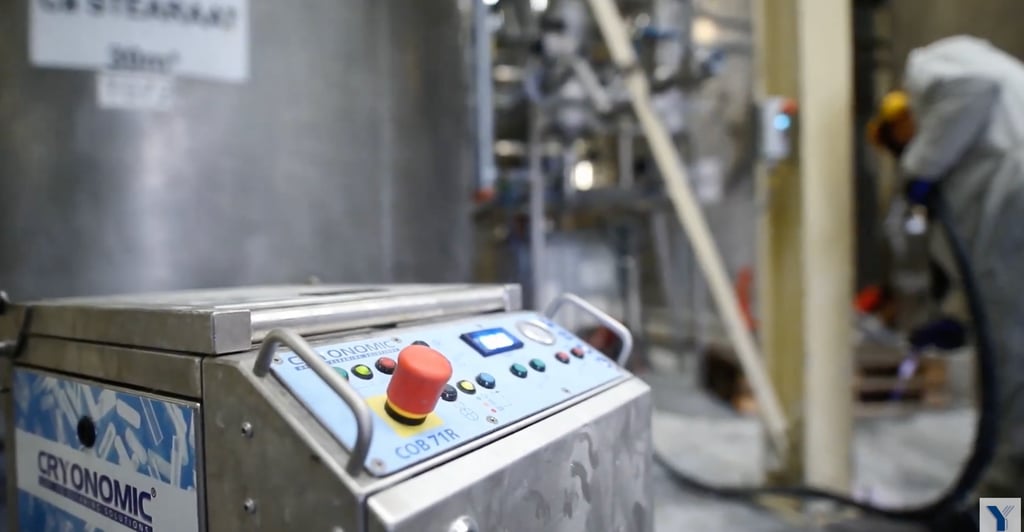 A CRYONOMIC COB 71R dry ice blasting machine being used for industrial cleaning in a factory facility.
