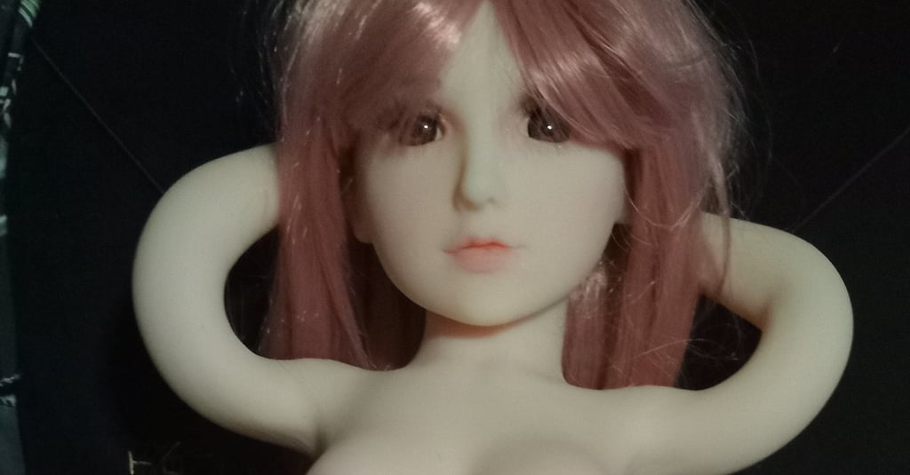 sex doll with breasts and vagina exposed with arms behind her head