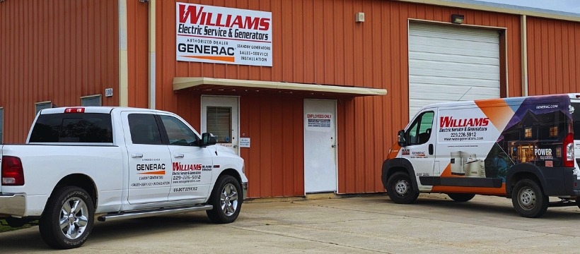Williams electric services & generators office and warehouse with two service vehicles in front 
