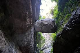 a rock formation in the middle of a narrow canyon