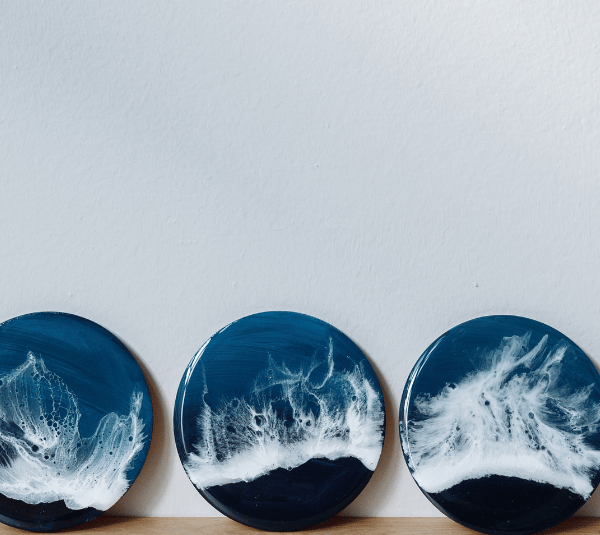 three plates with waves on it with the paint
