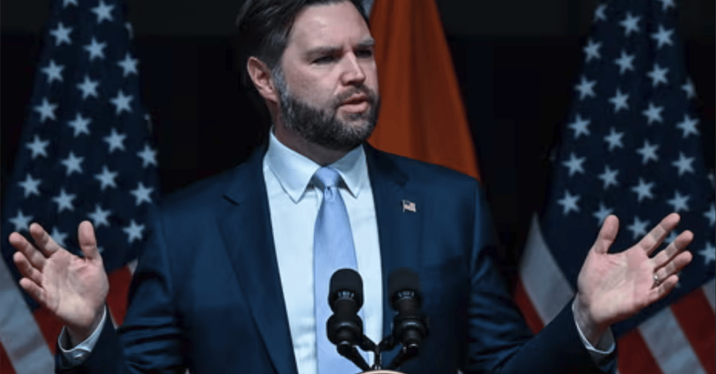 a man in a suit and tie standing at a podium