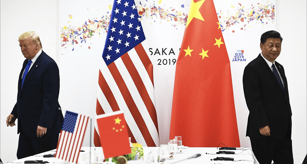 two men standing in front of a table with flags