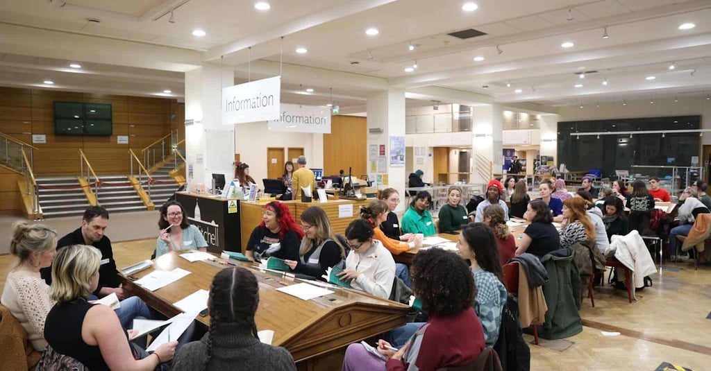 Participants engaged in a lively book club meeting in a community space, illustrating the communal a