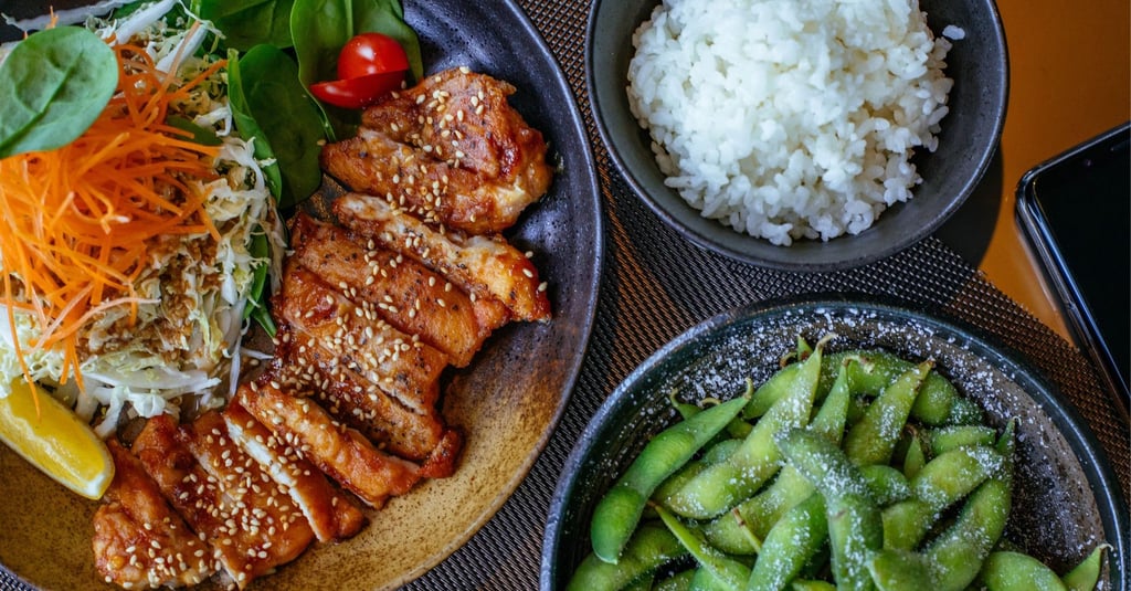 Grilled sesame chicken teriyaki served with fresh garden salad, white rice, and salted edamame.
