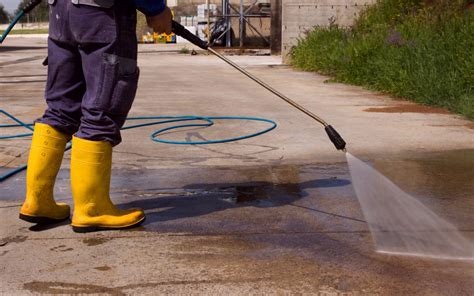 Pressure washing services worker pressure washing a dirty sidewalk