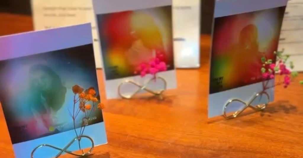Aura portraits on stands with small dried flowers.
