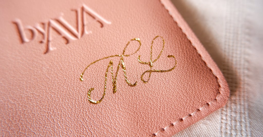 A leather pouch customized with gold foiling initials by New York calligrapher Handwritten by Belle.