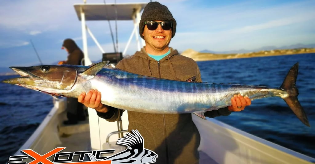 a man holding a fish on a boat