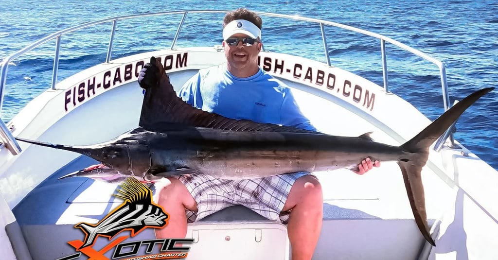 a man holding a fish on a boat