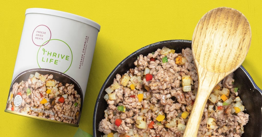 thrive sausage crumbles in a skillet with wooden spoon
