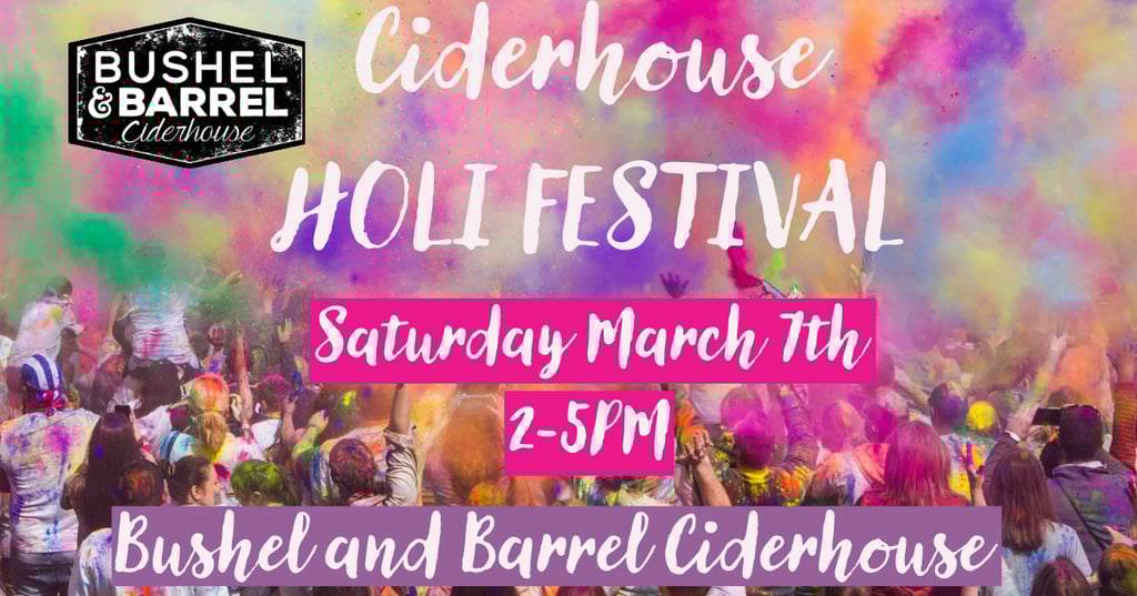 Crowd celebrating at the Bushel and Barrel Ciderhouse Holi Festival with colorful powder clouds.