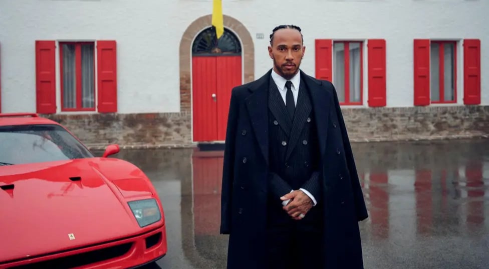 Lewis Hamilton in a suit and coat with his Ferrari.