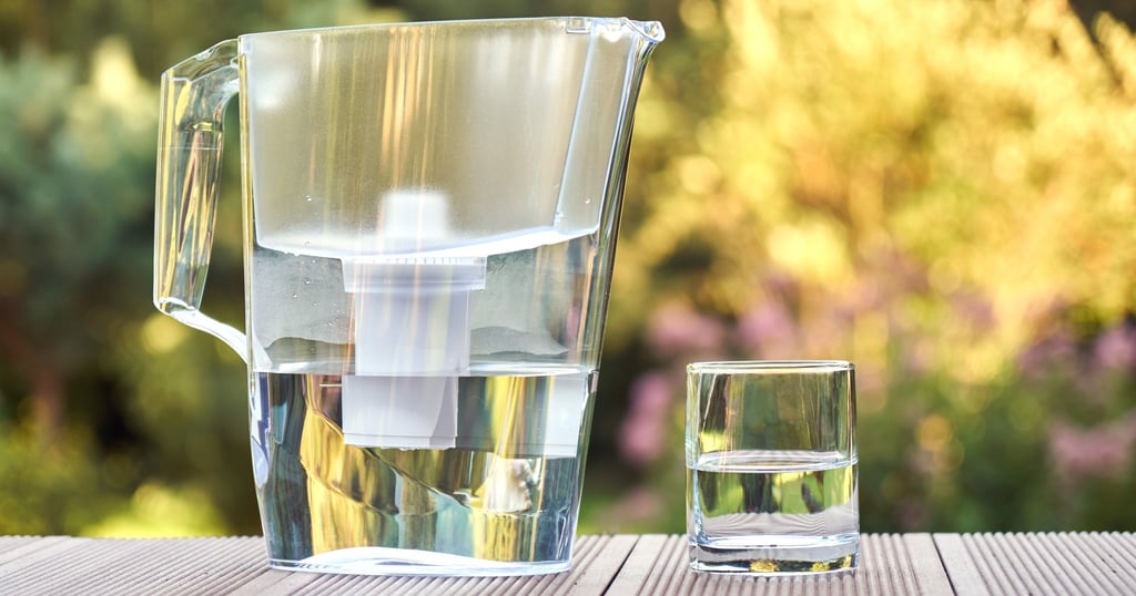 Eco-friendly water filter pitcher with a clean glass of water, sustainable alternative to bottled wa