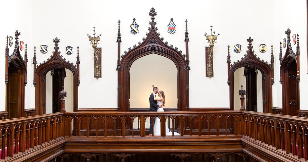 bride and groom in a romantic pose, groom kissing bride in castle, symmetrical composition