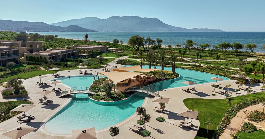 Deluxe swimming pool at Ikos Kissamos and mountains in the background.