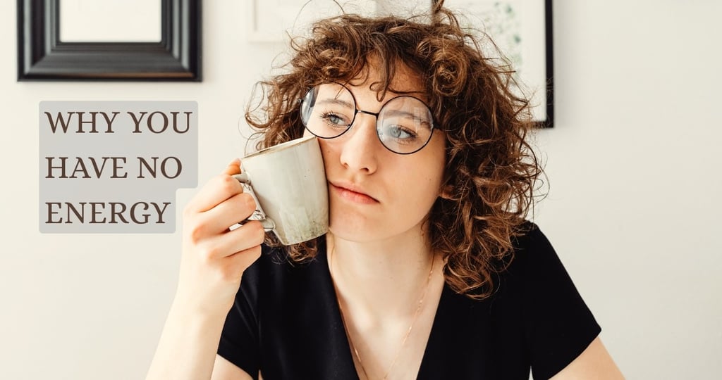 Woman looking tired while holding a coffee mug, representing low energy and daytime fatigue in women