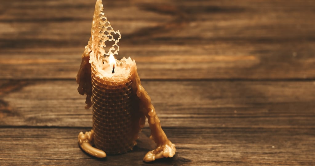 Eco-friendly beeswax candle burning naturally on a wooden table, sustainable alternative to paraffin