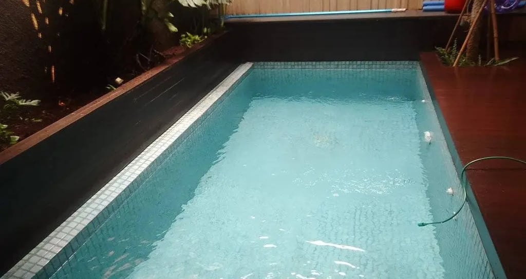 a pool with a pool and a wooden deck