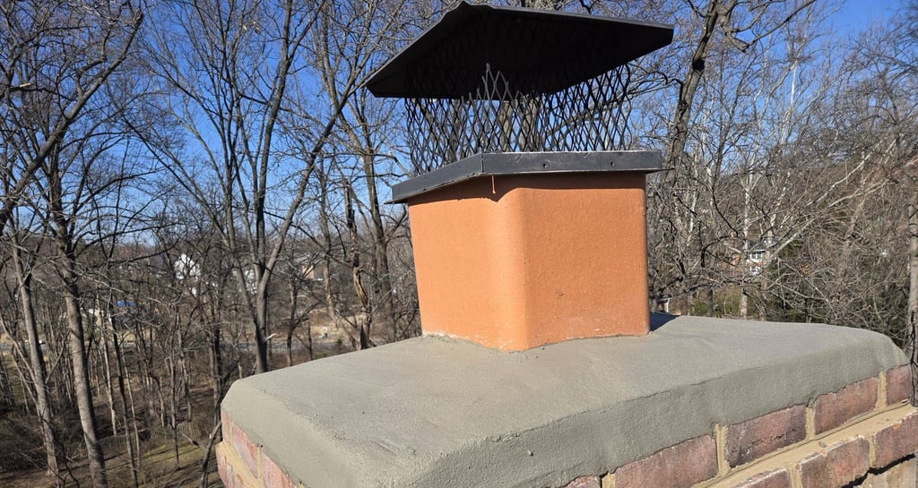 A newly installed concrete chimney crown and metal cap on a brick chimney by Roslyn Chimney
