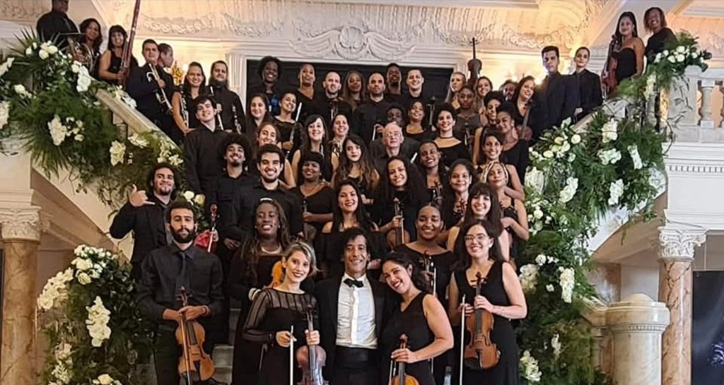 a group of musicians and musicians in a large room