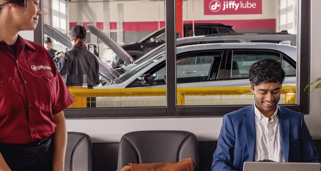 Jiffy Lube employee standing and observing the service area.