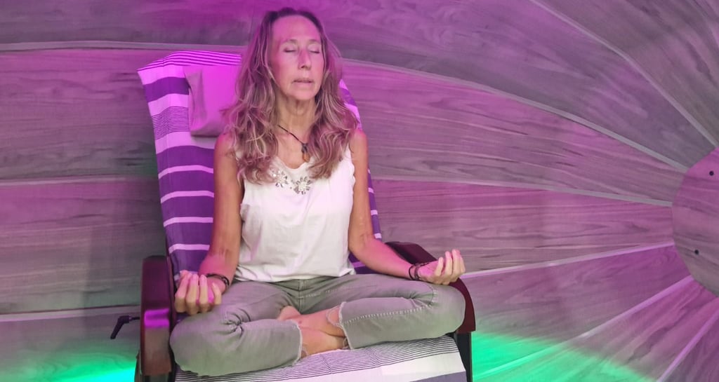 Client relaxing inside the Harmonic Egg for bio-energy and sound frequency therapy.