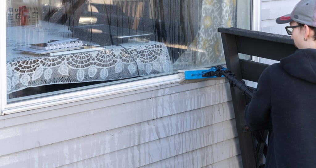 Man Cleaning Window Frame
